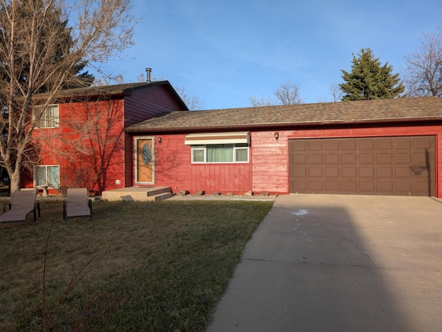 2599 Pike Dr, East Helena, MT 59635 - split level home featuring a front yard, an attached garage, driveway, and roof with shingles