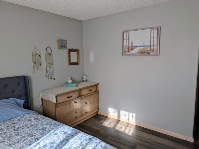 2599 Pike Dr, East Helena, MT 59635 - bedroom featuring baseboards, wood finished floors, and a textured ceiling