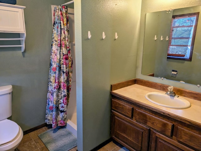2599 Pike Dr, East Helena, MT 59635 - full bath with a shower with curtain, vanity, toilet, tile patterned floors, and baseboards
