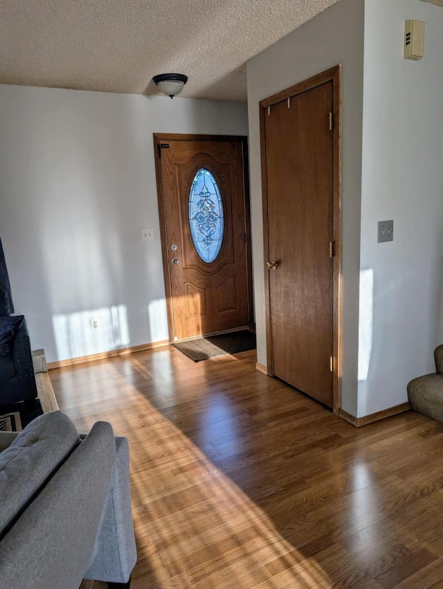 2599 Pike Dr, East Helena, MT 59635 - foyer entrance with baseboards, a textured ceiling, and wood finished floors