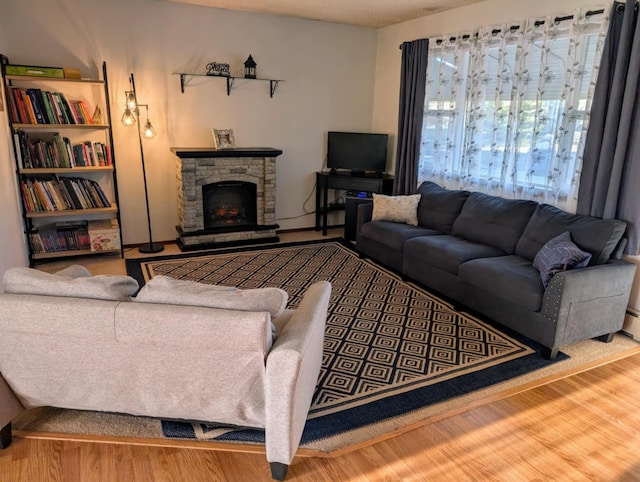 2599 Pike Dr, East Helena, MT 59635 - living area with a stone fireplace and wood finished floors