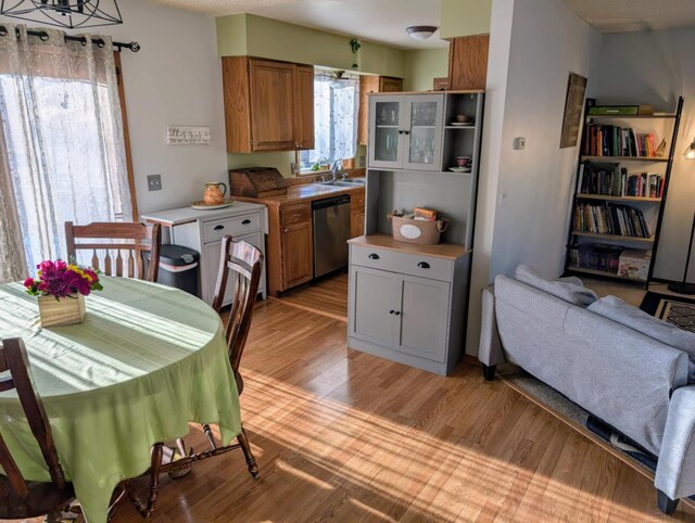 2599 Pike Dr, East Helena, MT 59635 - kitchen with light countertops, light wood-style floors, brown cabinetry, stainless steel dishwasher, and a sink