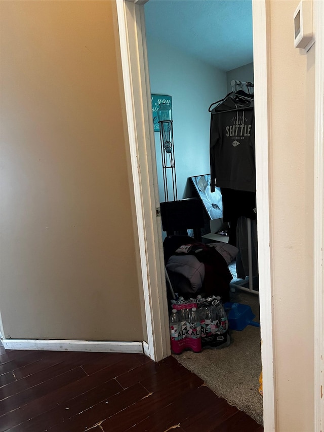 walk in closet with wood finished floors