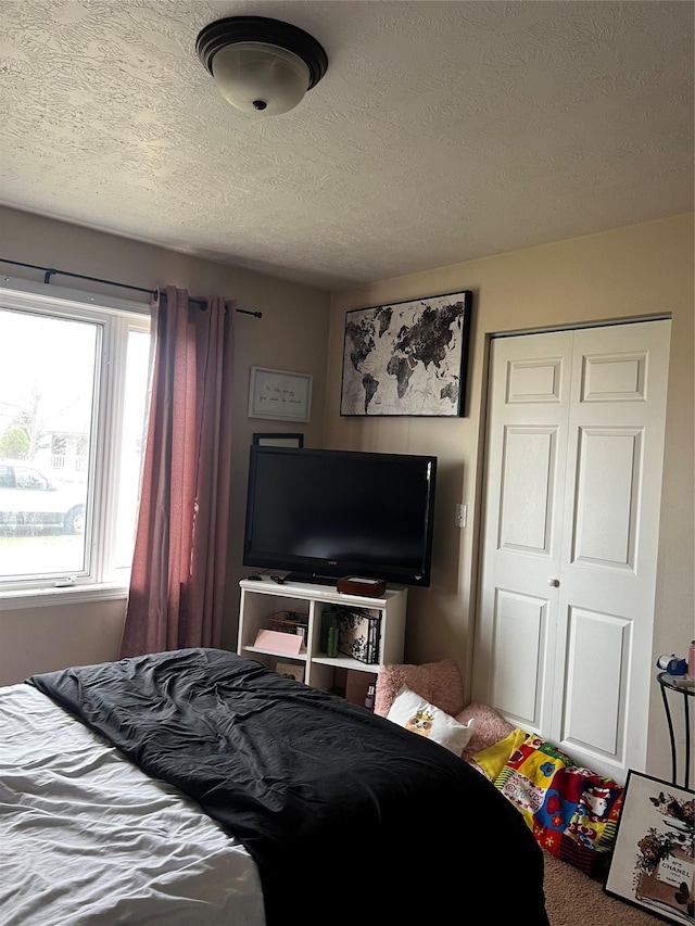 bedroom with a closet and a textured ceiling
