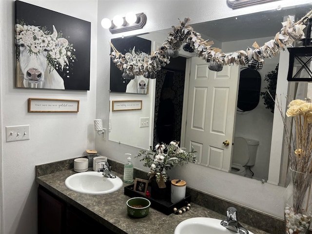 bathroom featuring a sink and double vanity