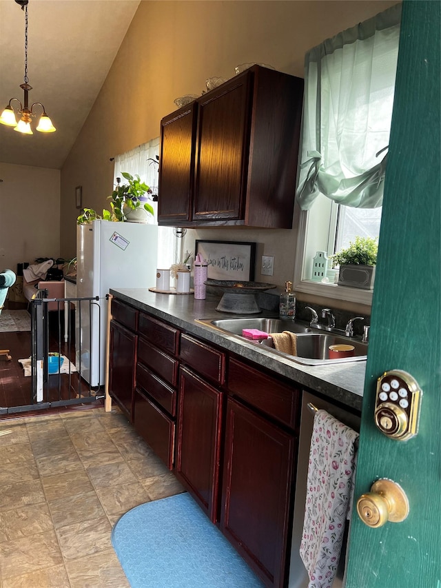 kitchen with hanging light fixtures, a sink, dark countertops, a chandelier, and high vaulted ceiling