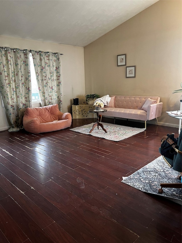 living room with hardwood / wood-style floors and lofted ceiling