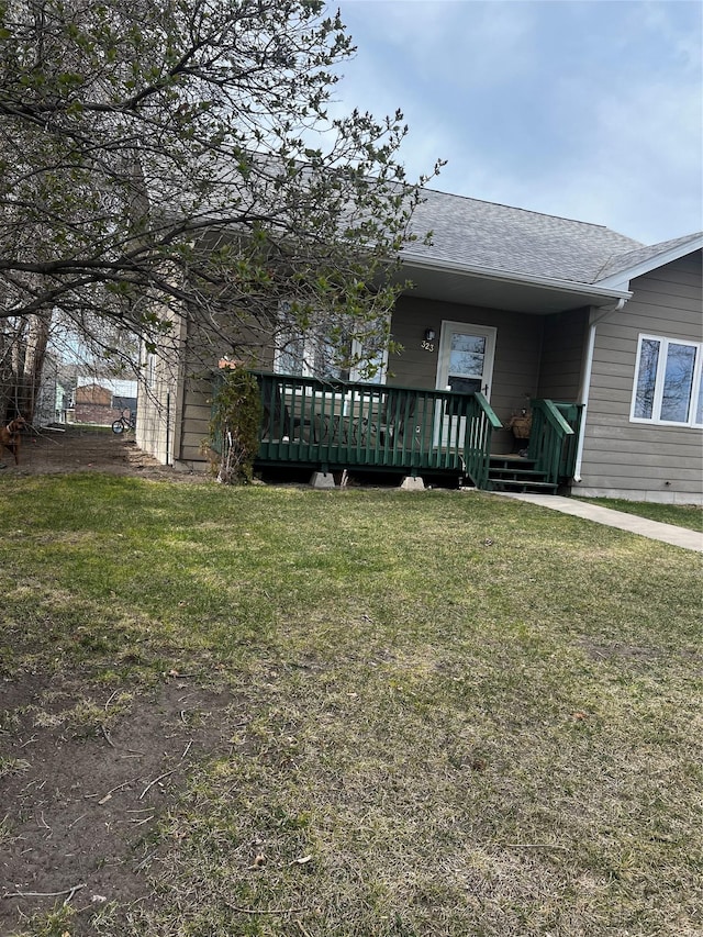 single story home with roof with shingles and a front lawn