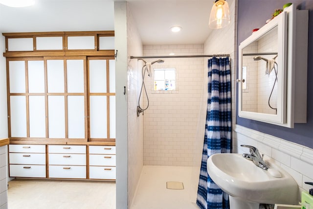 full bath with a sink and a stall shower