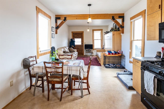 dining area with beamed ceiling, a wealth of natural light, and baseboards