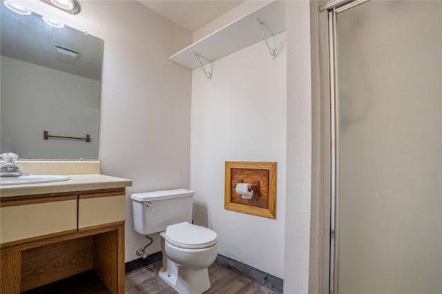 701 N Davis St Unit A, Helena, MT 59601 - bathroom featuring wood finished floors, vanity, and a shower with shower door