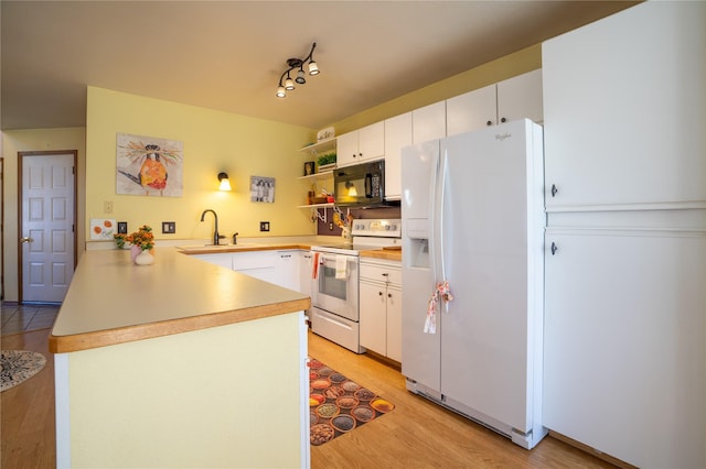 701 N Davis St Unit A, Helena, MT 59601 - kitchen featuring white appliances, a peninsula, light wood-style floors, open shelves, and white cabinets