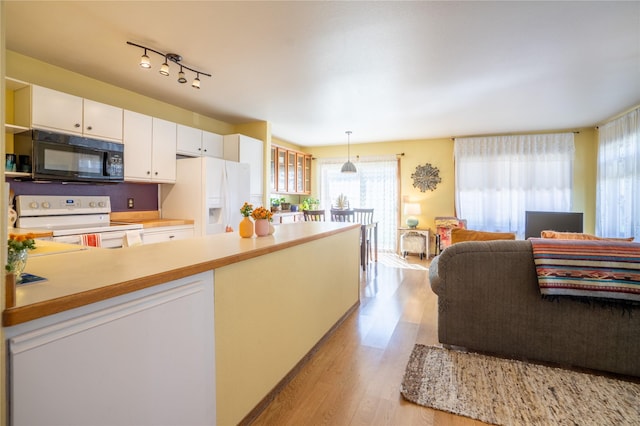 701 N Davis St Unit A, Helena, MT 59601 - kitchen featuring white appliances, light wood finished floors, white cabinets, light countertops, and open floor plan