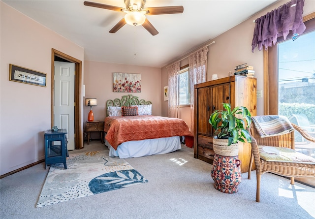 701 N Davis St Unit A, Helena, MT 59601 - bedroom with carpet floors, a wood stove, and ceiling fan