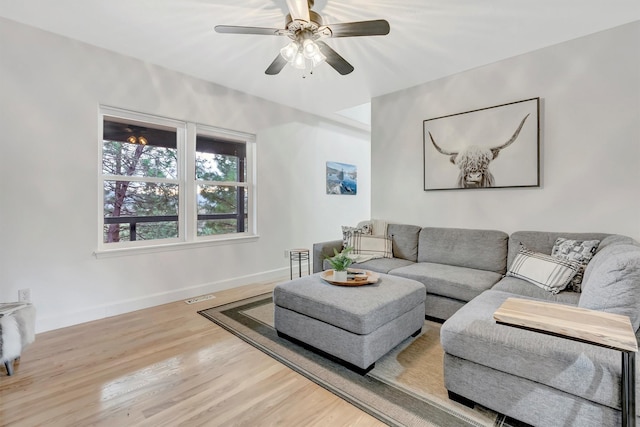15022 Romulus Ln, Frenchtown, MT 59834 - living room with baseboards, wood finished floors, and ceiling fan