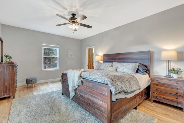 15022 Romulus Ln, Frenchtown, MT 59834 - bedroom with wood finished floors, baseboards, and a ceiling fan