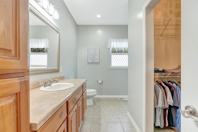 15022 Romulus Ln, Frenchtown, MT 59834 - bathroom featuring plenty of natural light, toilet, tile patterned flooring, and vanity