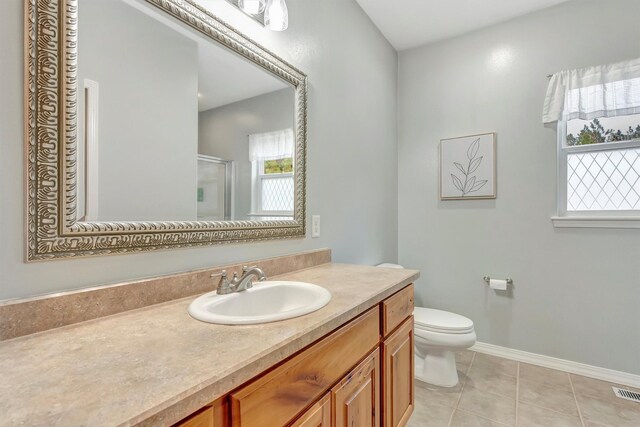 15022 Romulus Ln, Frenchtown, MT 59834 - bathroom with a stall shower, vanity, baseboards, toilet, and tile patterned flooring