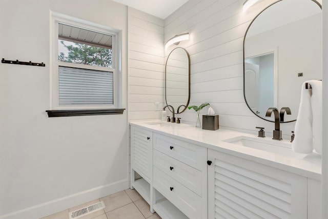 15022 Romulus Ln, Frenchtown, MT 59834 - bathroom featuring tile patterned floors, baseboards, double vanity, and wooden walls