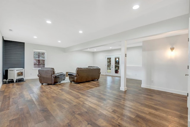 15022 Romulus Ln, Frenchtown, MT 59834 - living room featuring baseboards, wood finished floors, a wood stove, recessed lighting, and french doors