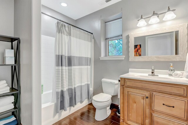 15022 Romulus Ln, Frenchtown, MT 59834 - bathroom with toilet, vanity, shower / tub combo, wood finished floors, and baseboards