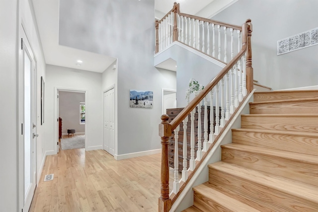 15022 Romulus Ln, Frenchtown, MT 59834 - staircase with wood finished floors, a towering ceiling, and baseboards