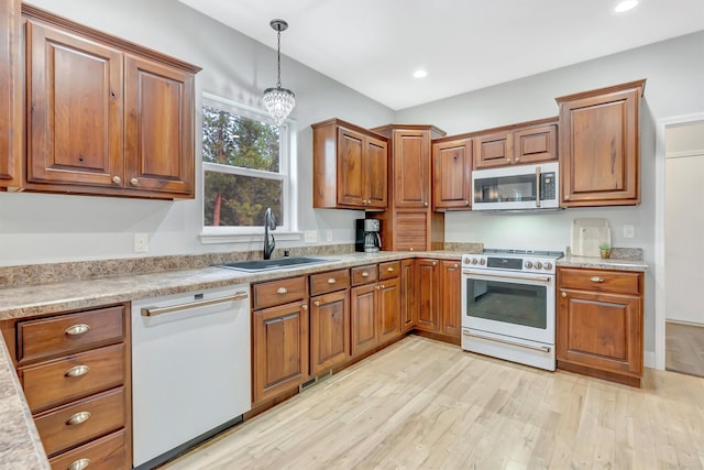 15022 Romulus Ln, Frenchtown, MT 59834 - kitchen with stainless steel microwave, gas stove, a sink, dishwasher, and brown cabinets