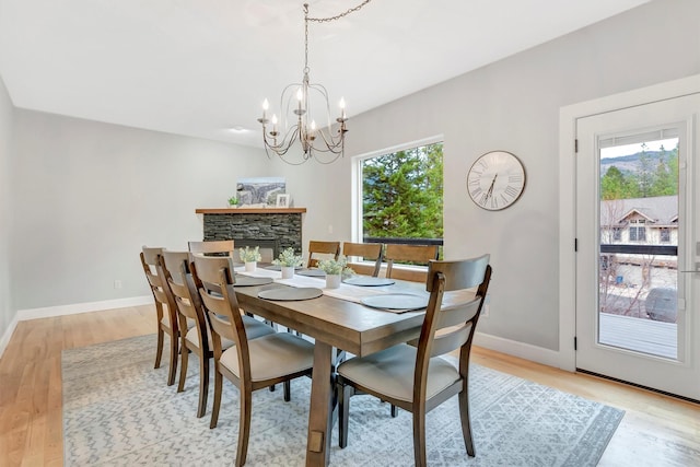 15022 Romulus Ln, Frenchtown, MT 59834 - dining space featuring plenty of natural light, a chandelier, light wood-style floors, and baseboards