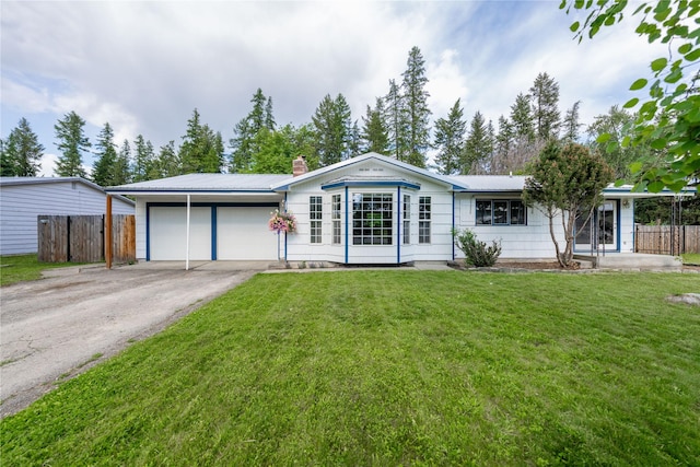 139 Highwood Dr, Libby, MT 59923 - ranch-style home featuring an attached garage, asphalt driveway, a chimney, and a metal roof
