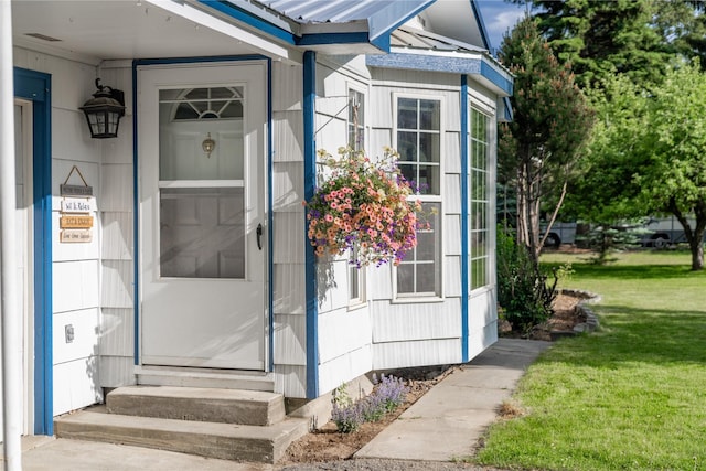 139 Highwood Dr, Libby, MT 59923 - property entrance featuring a metal roof and a lawn