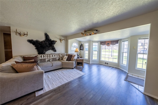 139 Highwood Dr, Libby, MT 59923 - living area with a textured ceiling, dark wood-style floors, and baseboards