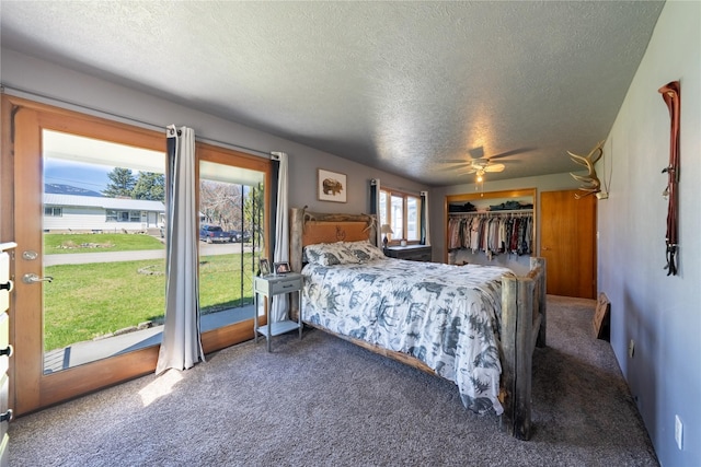 139 Highwood Dr, Libby, MT 59923 - bedroom featuring a textured ceiling, carpet flooring, ceiling fan, and access to outside