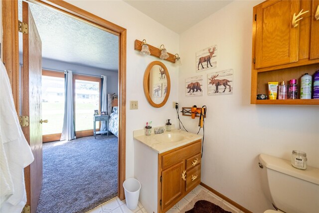 139 Highwood Dr, Libby, MT 59923 - bathroom featuring vanity, toilet, and baseboards