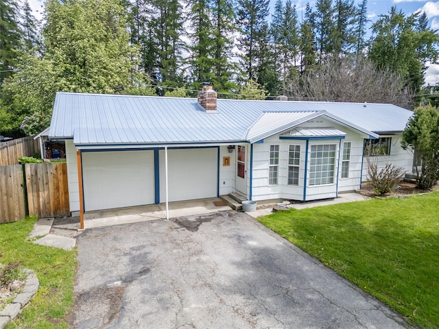 139 Highwood Dr, Libby, MT 59923 - ranch-style home featuring a chimney, driveway, an attached garage, and metal roof