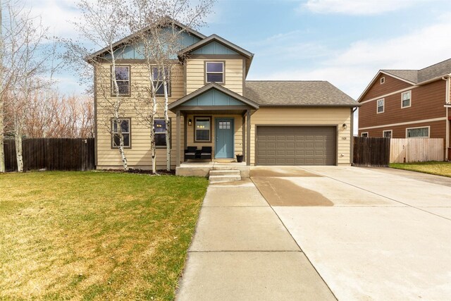 1101 E Gallatin Ave, Belgrade, MT 59714 - view of front of home with a front yard, an attached garage, fence, and concrete driveway