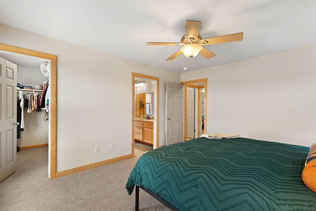 1101 E Gallatin Ave, Belgrade, MT 59714 - bedroom featuring baseboards, ceiling fan, carpet, a walk in closet, and connected bathroom