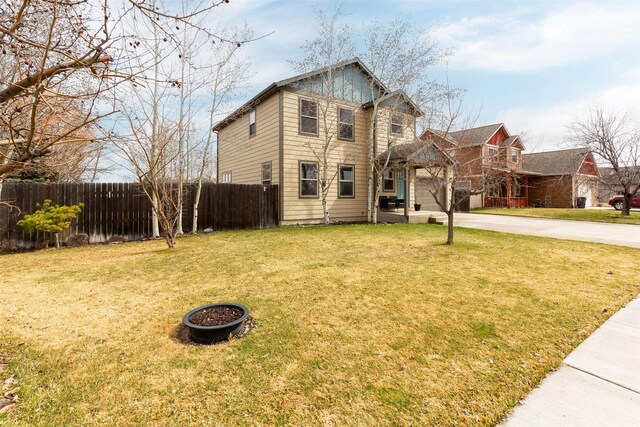 1101 E Gallatin Ave, Belgrade, MT 59714 - traditional home featuring driveway, fence, and a front lawn