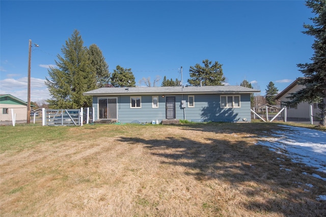 view of front of property with fence, a front lawn, and a gate