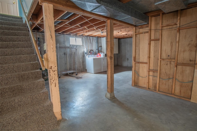 below grade area with washer and clothes dryer and stairs