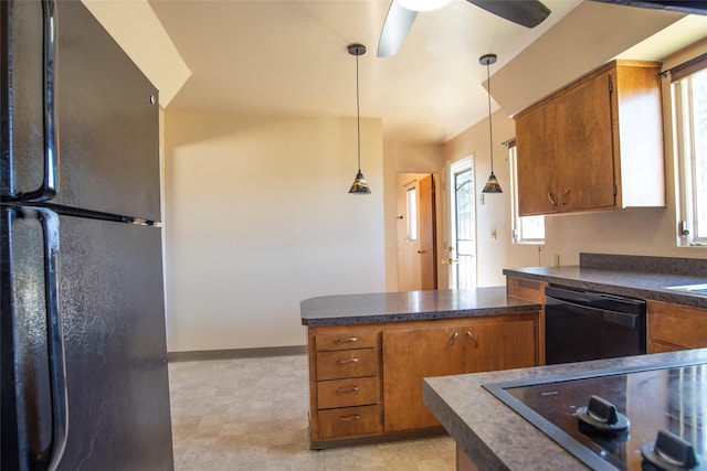kitchen featuring dark countertops, black appliances, a peninsula, and brown cabinets