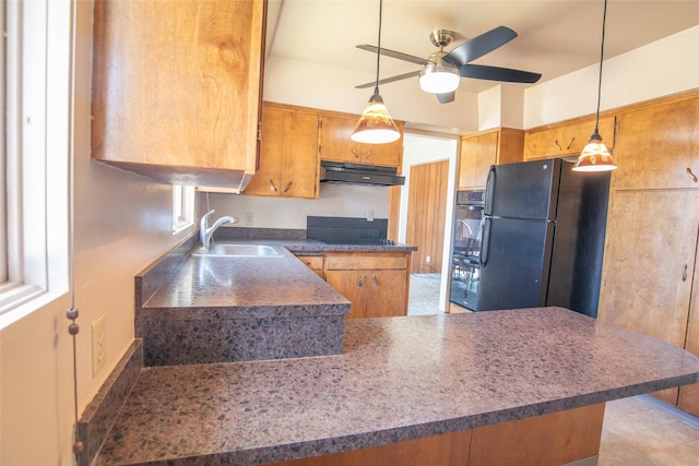 kitchen featuring a sink, a peninsula, a ceiling fan, under cabinet range hood, and black appliances
