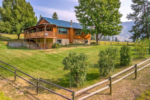708 Johnson Ln, Superior, MT 59872 - rear view of house featuring a lawn, a deck, fence, and metal roof