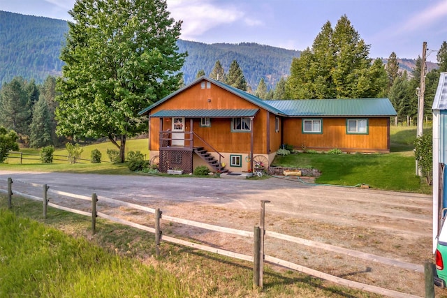 708 Johnson Ln, Superior, MT 59872 - chalet / cabin featuring a view of trees, metal roof, a mountain view, and a front lawn