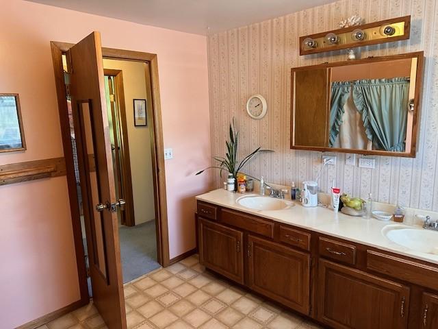 708 Johnson Ln, Superior, MT 59872 - bathroom featuring a sink, wallpapered walls, and double vanity