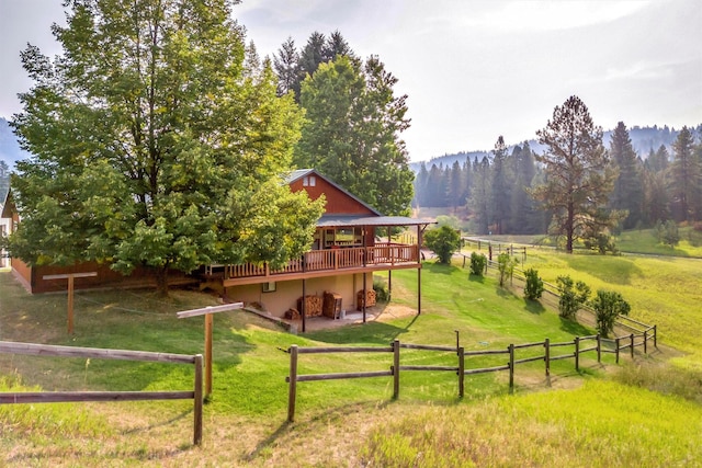 708 Johnson Ln, Superior, MT 59872 - view of yard with fence, a deck with mountain view, and a rural view