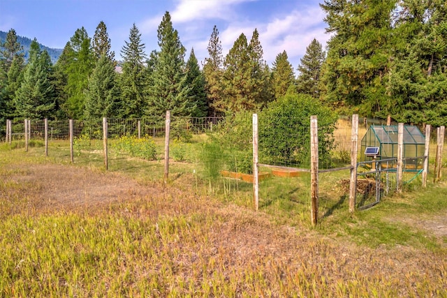708 Johnson Ln, Superior, MT 59872 - view of yard featuring fence, a garden, an outdoor structure, and a greenhouse
