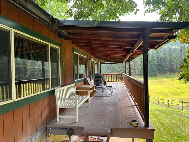 708 Johnson Ln, Superior, MT 59872 - wooden terrace with a lawn, fence, and grilling area