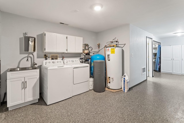 32306 St Ignatius Airport Rd, Saint Ignatius, MT 59865 - laundry area with water heater, cabinet space, and washing machine and dryer