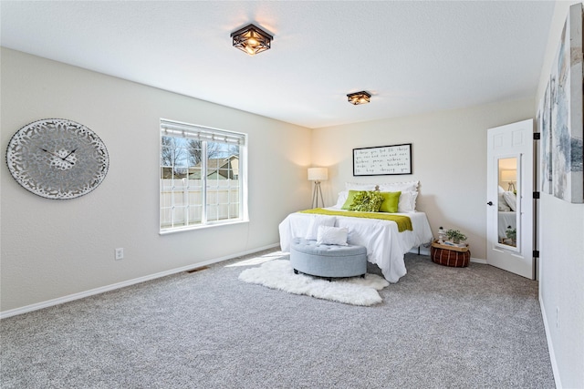 carpeted bedroom with visible vents and baseboards