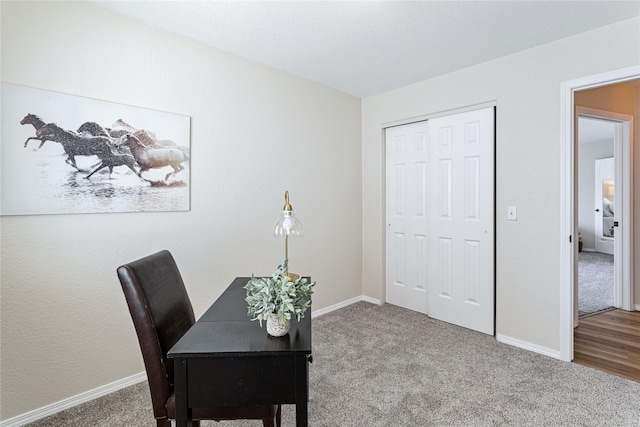 carpeted office featuring baseboards